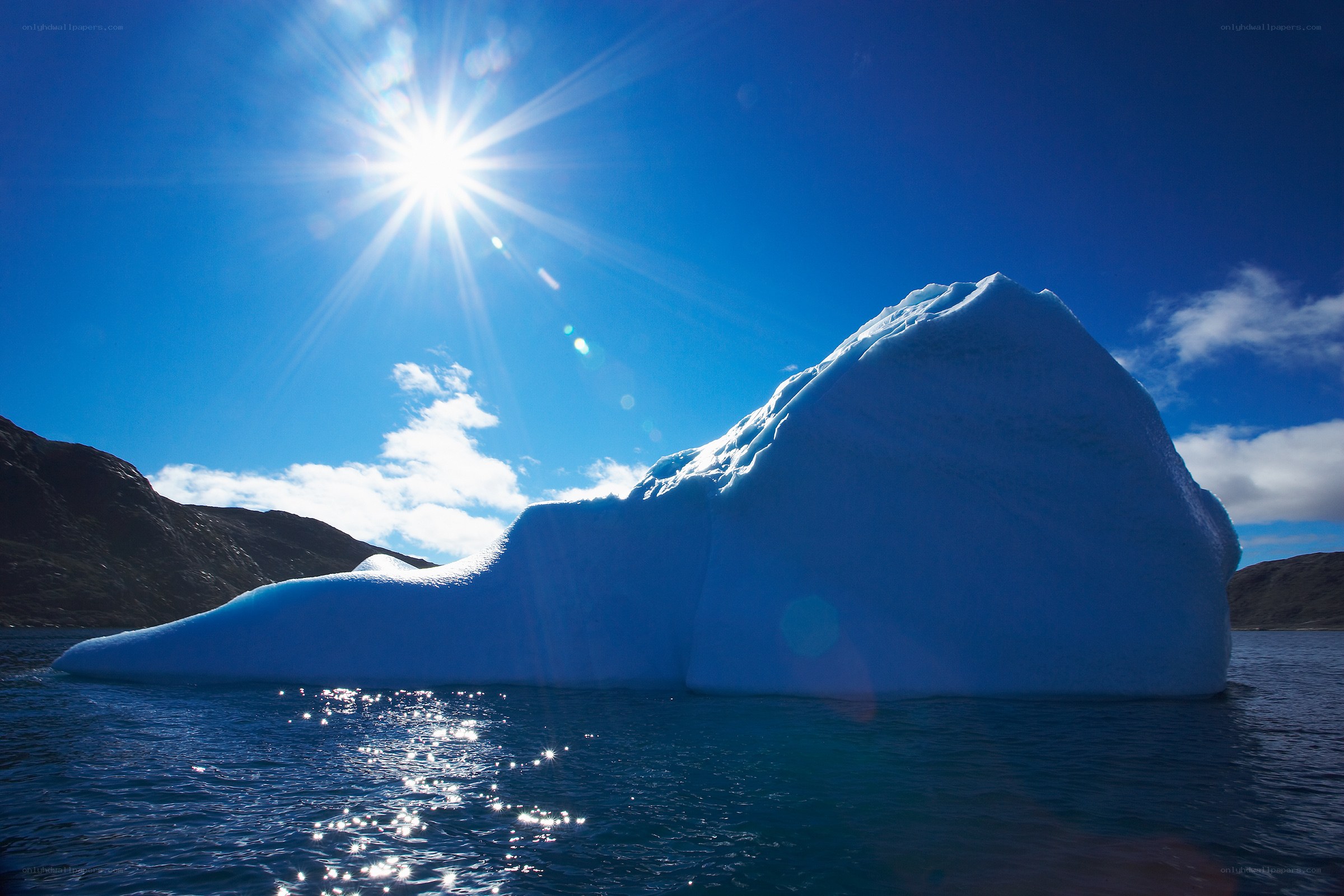 Sunlit iceberg in calm waters