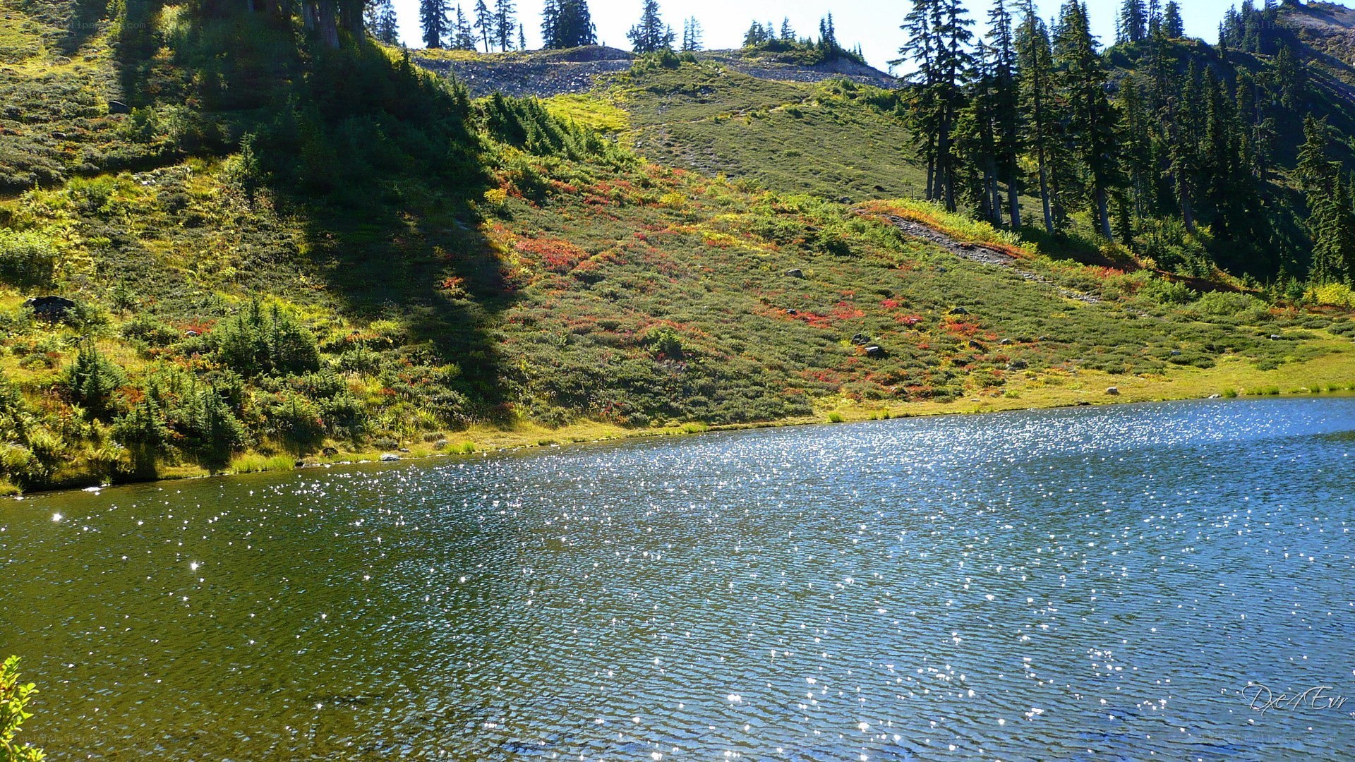 Sunlit lake in mountain valley