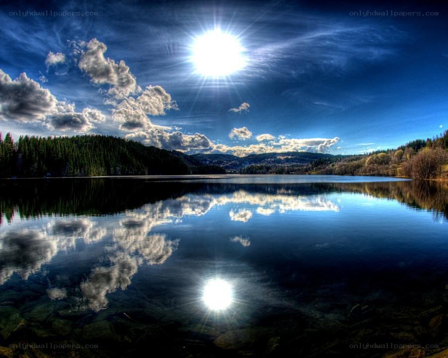 Sunlit lake with cloud reflection