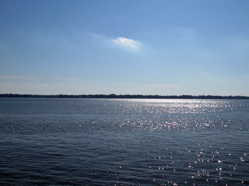 Sunlit lake with distant shore