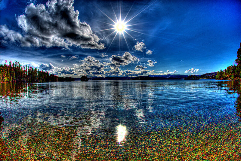 Sunlit lake with dramatic clouds