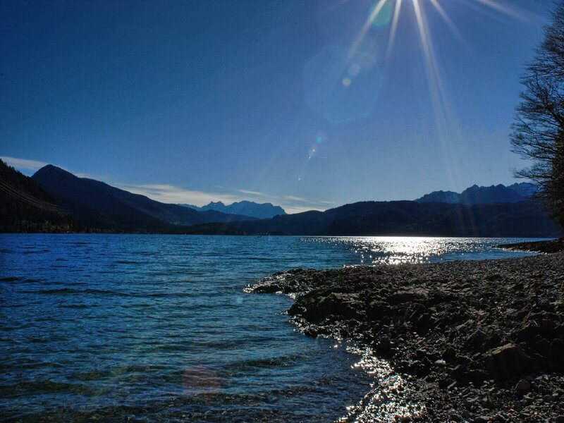 Sunlit lake with mountain backdrop