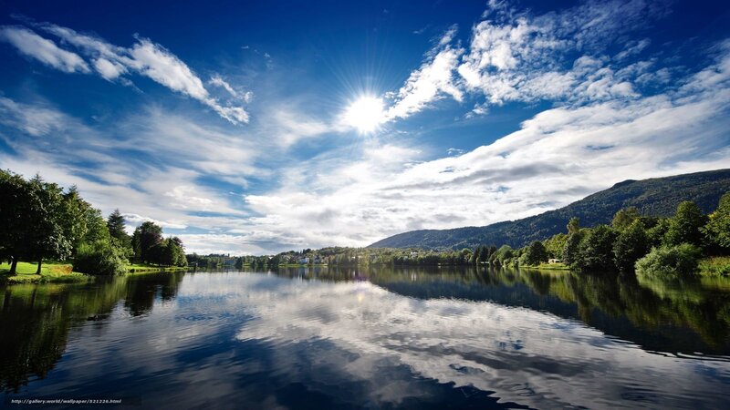 Sunlit lake with mountain reflection