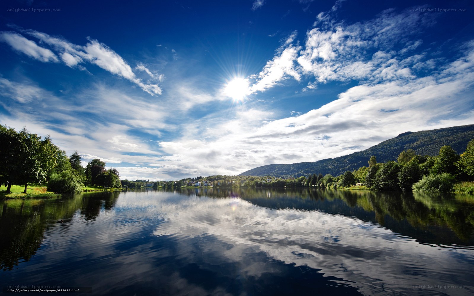 Sunlit lake with mountain reflection