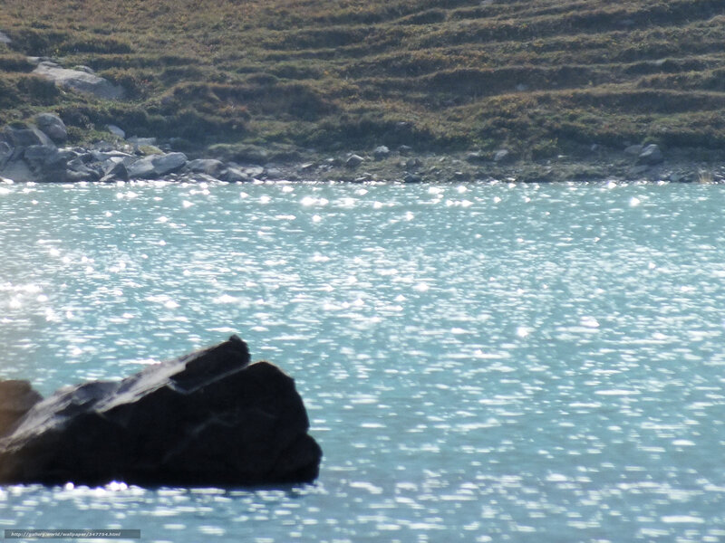 Sunlit lake with rocky shore