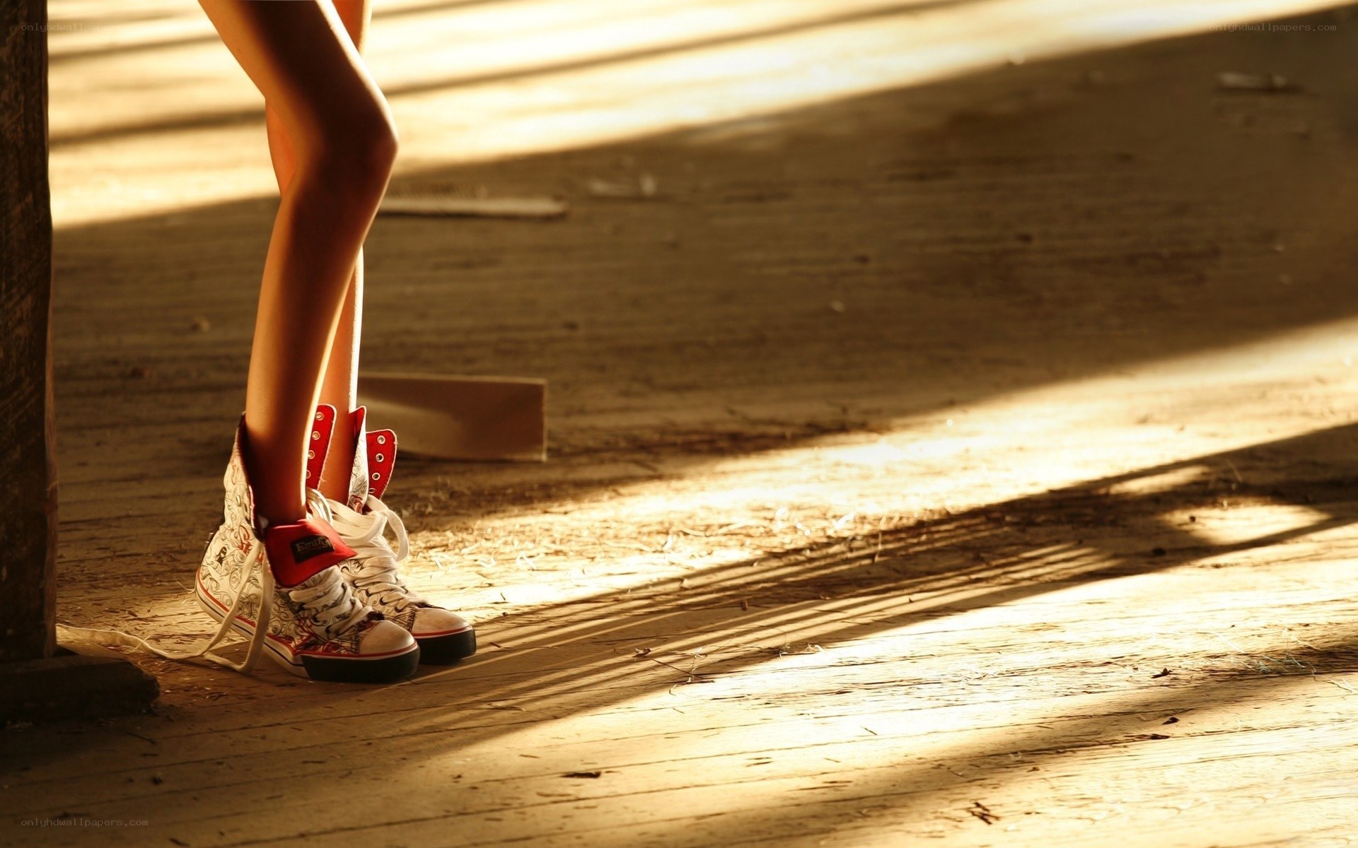 Sunlit legs in sneakers