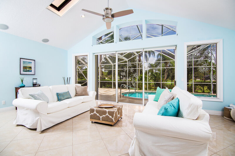Sunlit living room with pool view