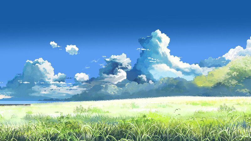 Sunlit meadow under blue sky