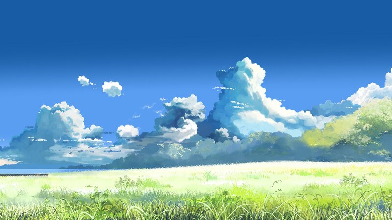 Sunlit meadow under blue sky