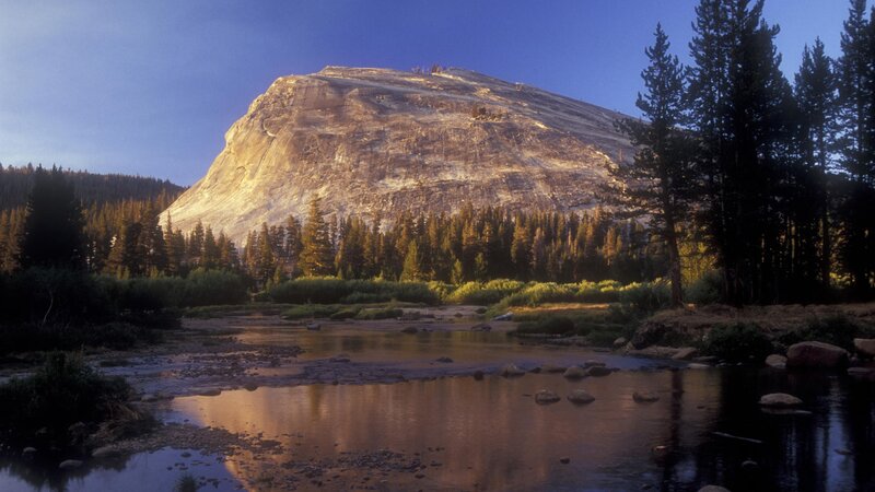 Sunlit mountain and river landscape