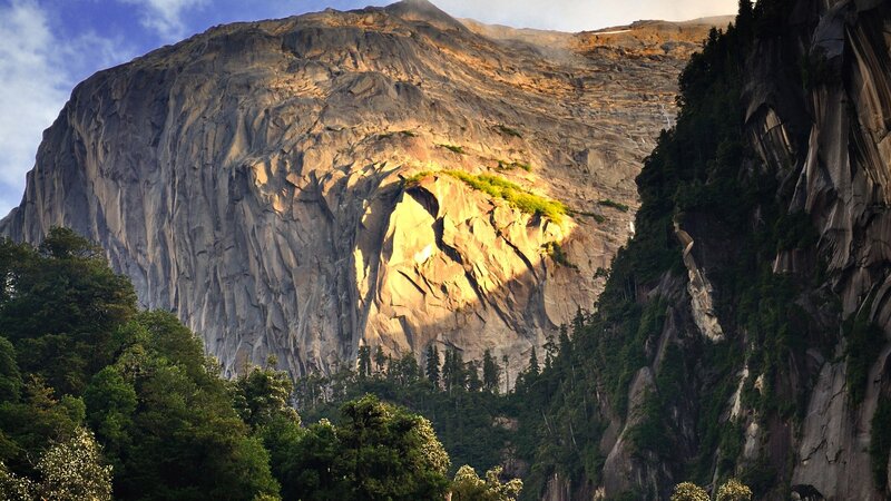 Sunlit mountain cliff face