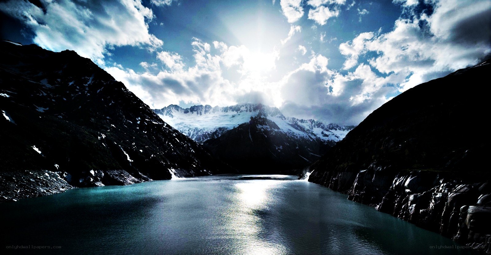 Sunlit mountain lake with glaciers