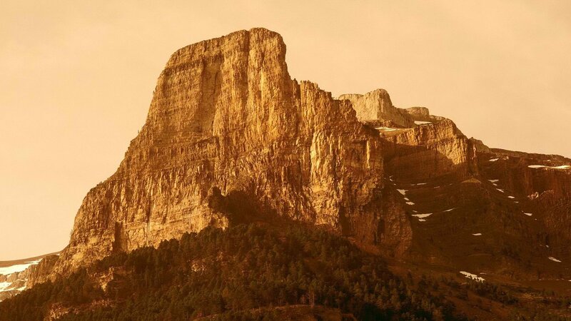 Sunlit mountain peak at dawn