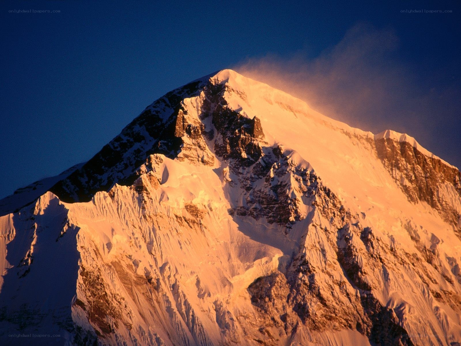 Sunlit mountain peak at dawn
