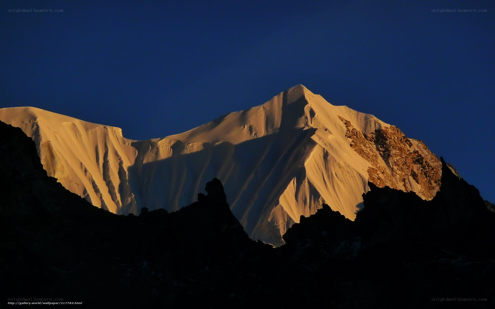 Sunlit mountain peak at dawn