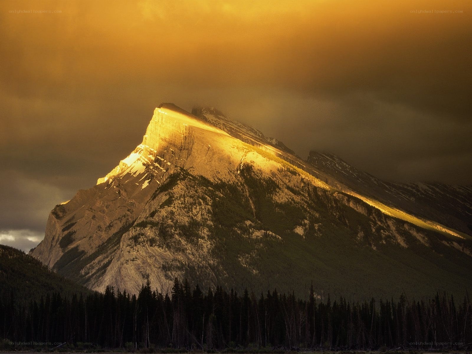 Sunlit mountain peak at dusk