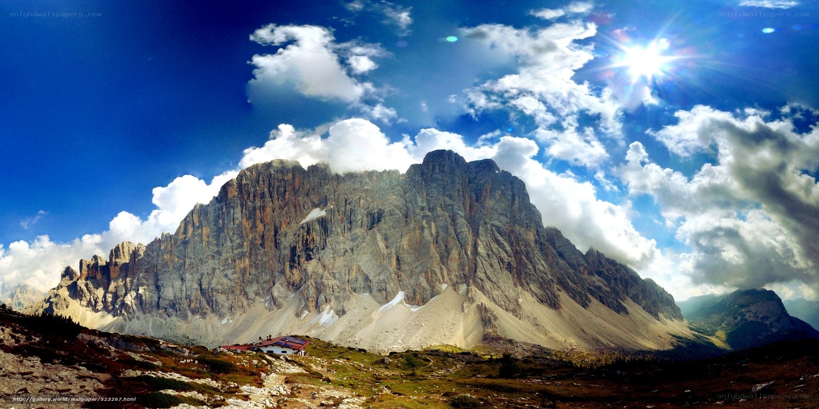 Sunlit mountain peak with clouds