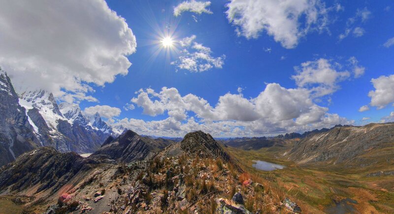 Sunlit mountain peaks and clouds