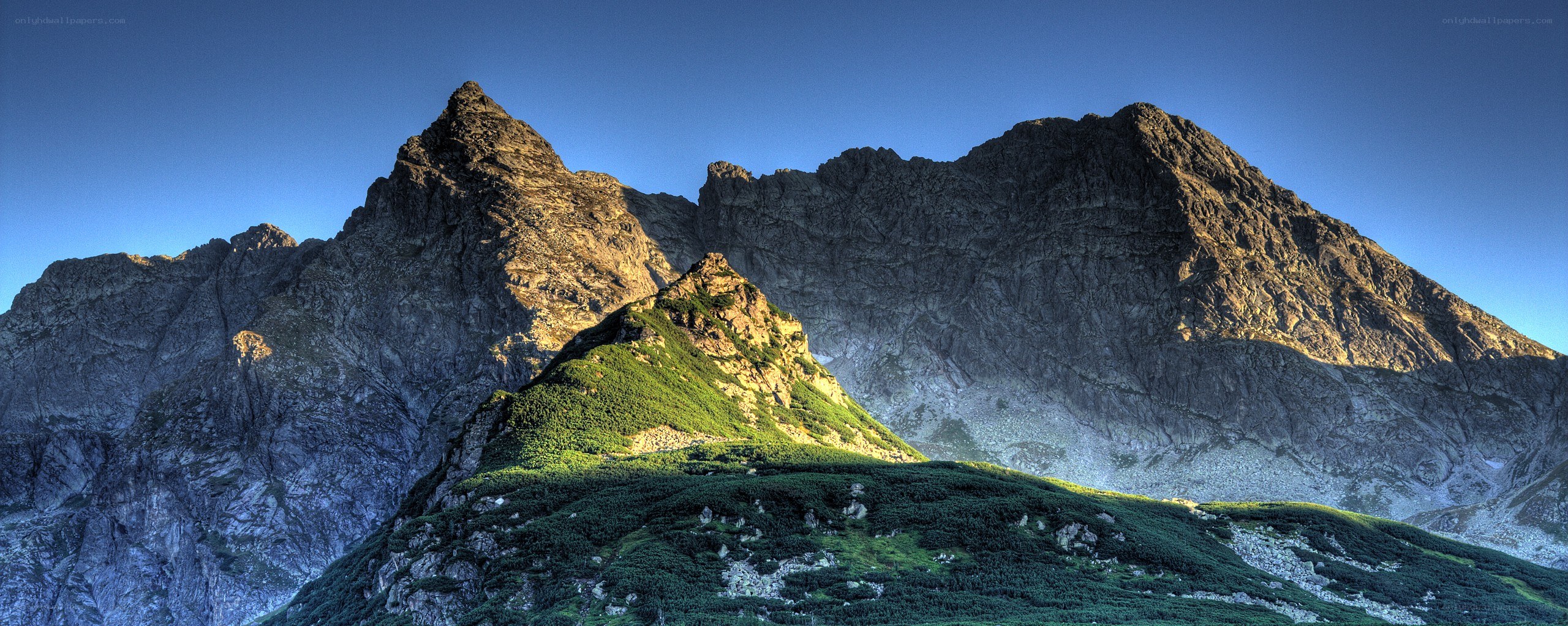 Sunlit mountain peaks at dawn