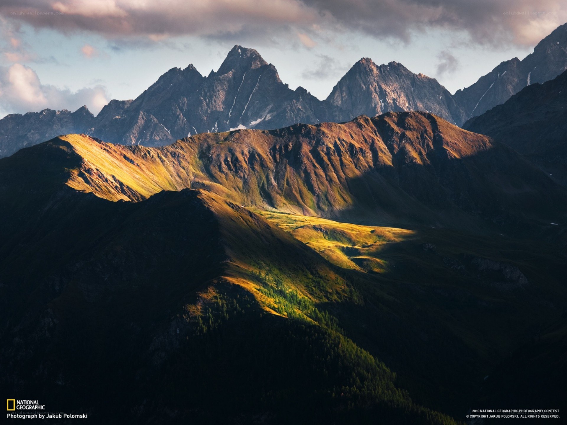 Sunlit mountain peaks at dawn