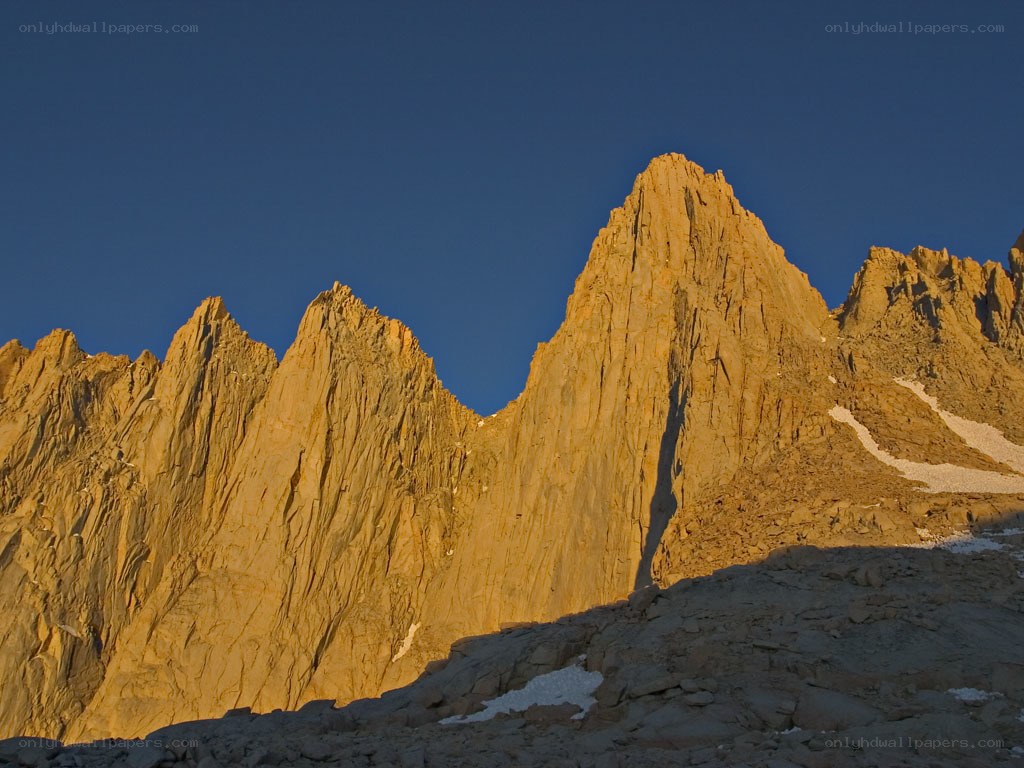Sunlit mountain peaks at dawn