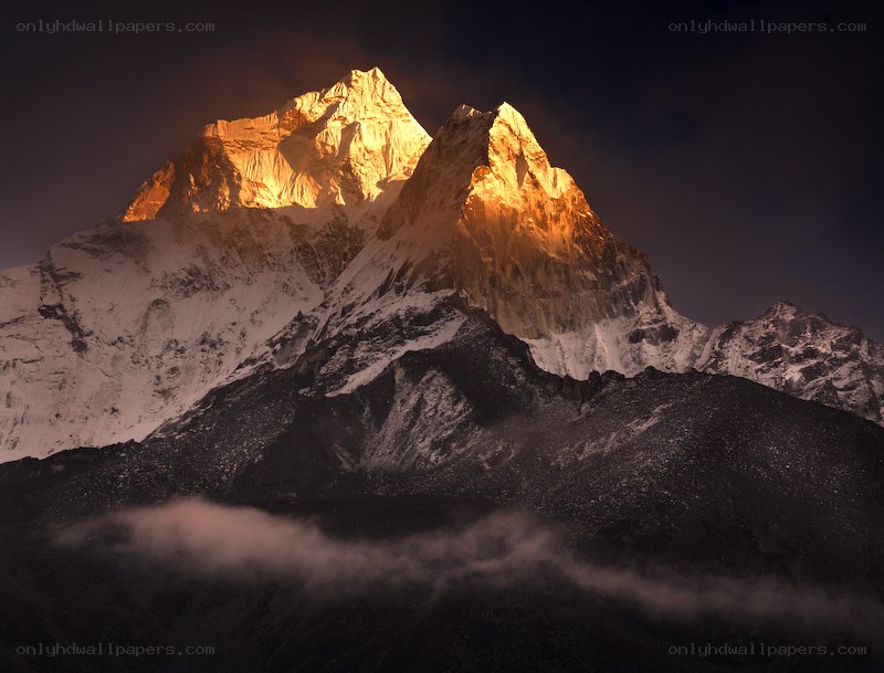 Sunlit mountain peaks at dawn