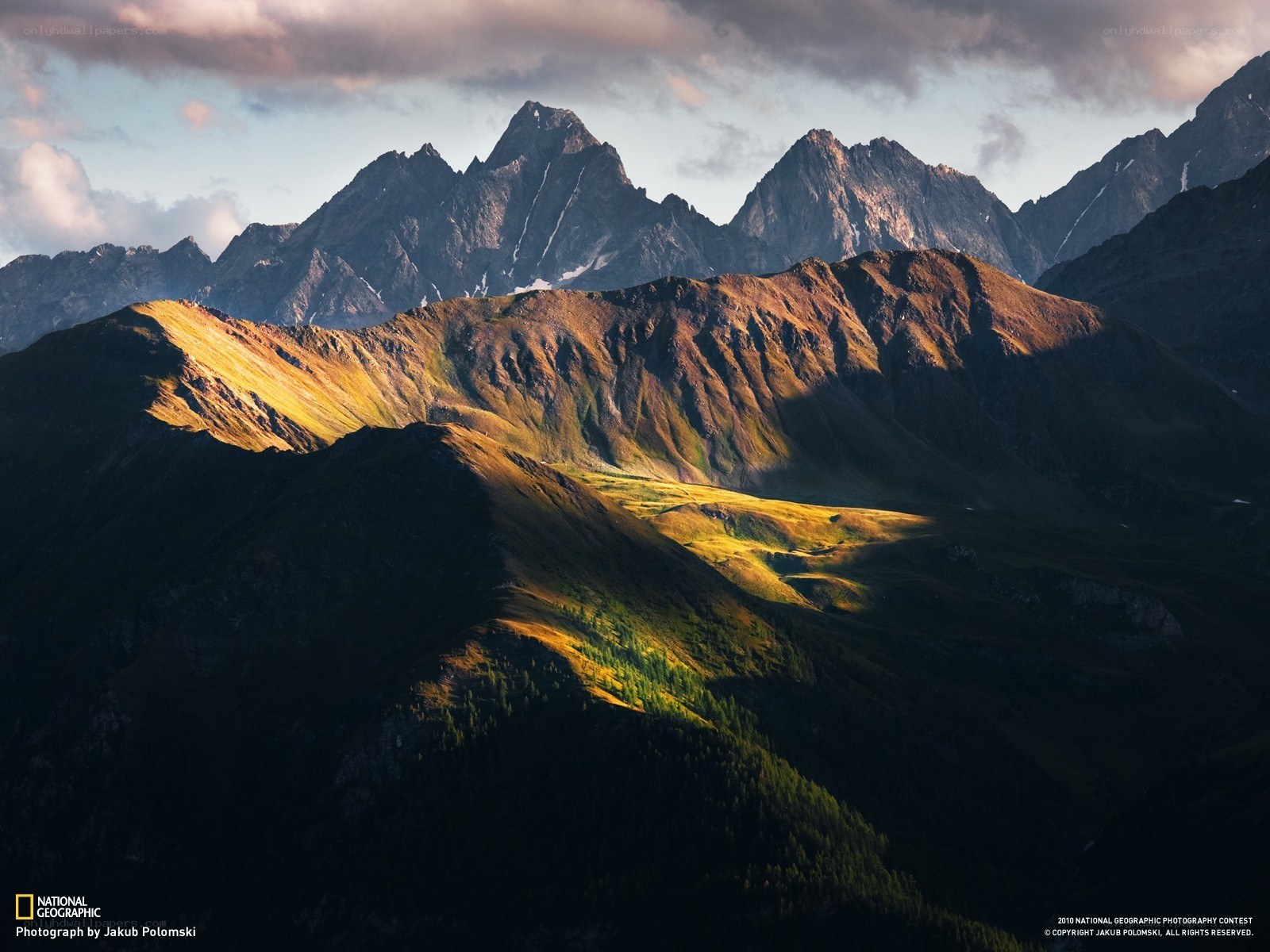 Sunlit mountain peaks at dawn