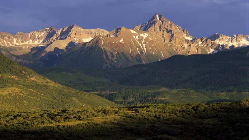Sunlit mountain range at dusk
