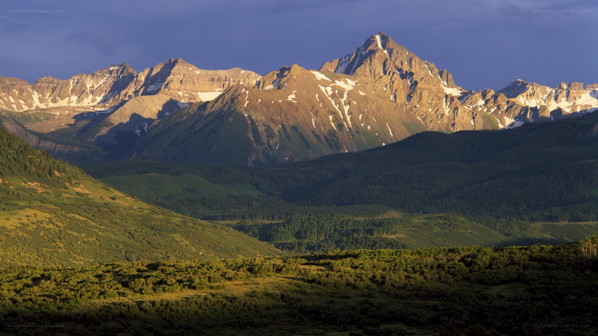 Sunlit mountain range at dusk