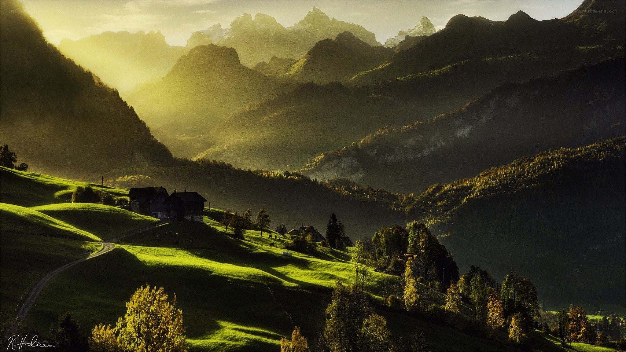 Sunlit mountain valley at dawn