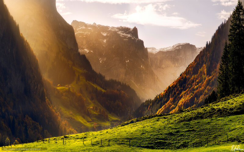 Sunlit mountain valley at dawn