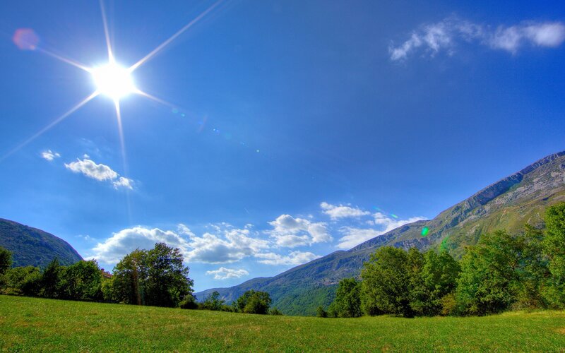 Sunlit mountain valley landscape