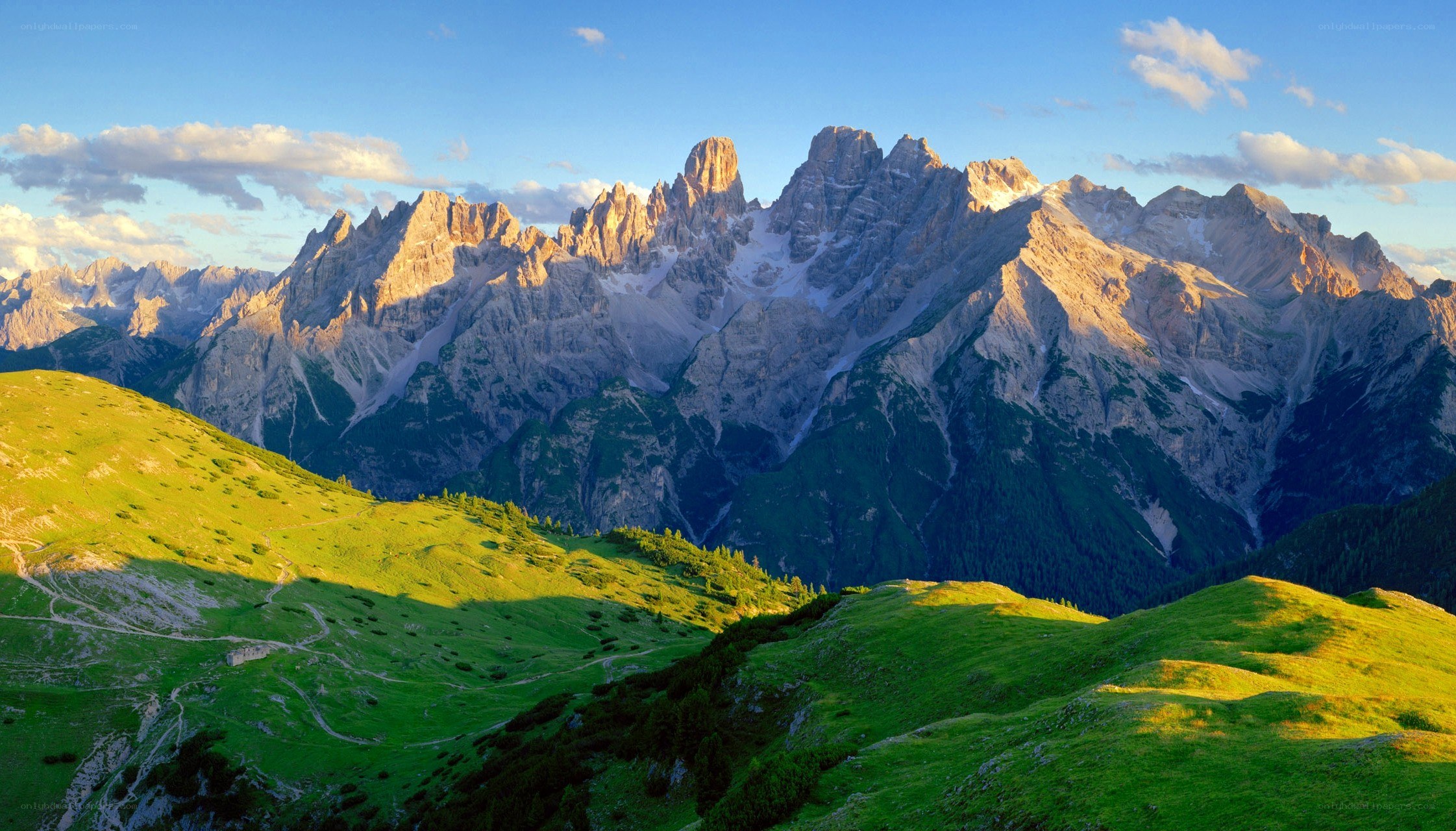 Sunlit mountains and green hills