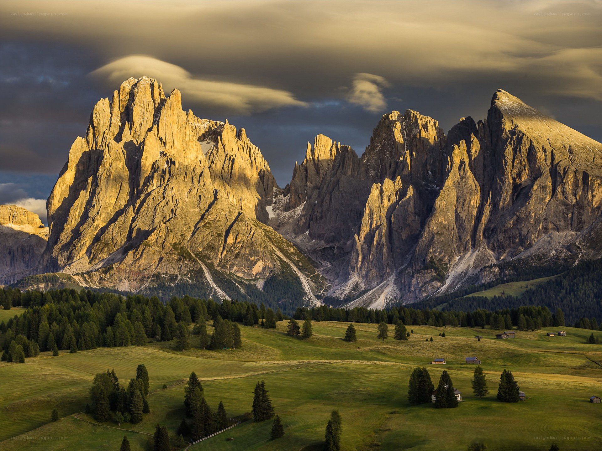 Sunlit mountains and green valley