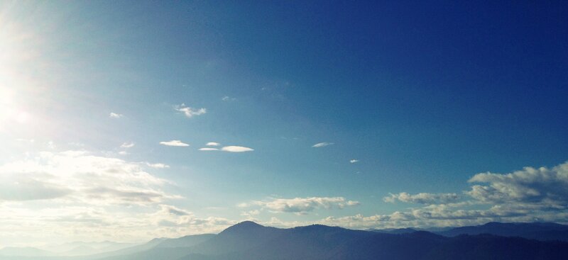 Sunlit mountains under blue sky
