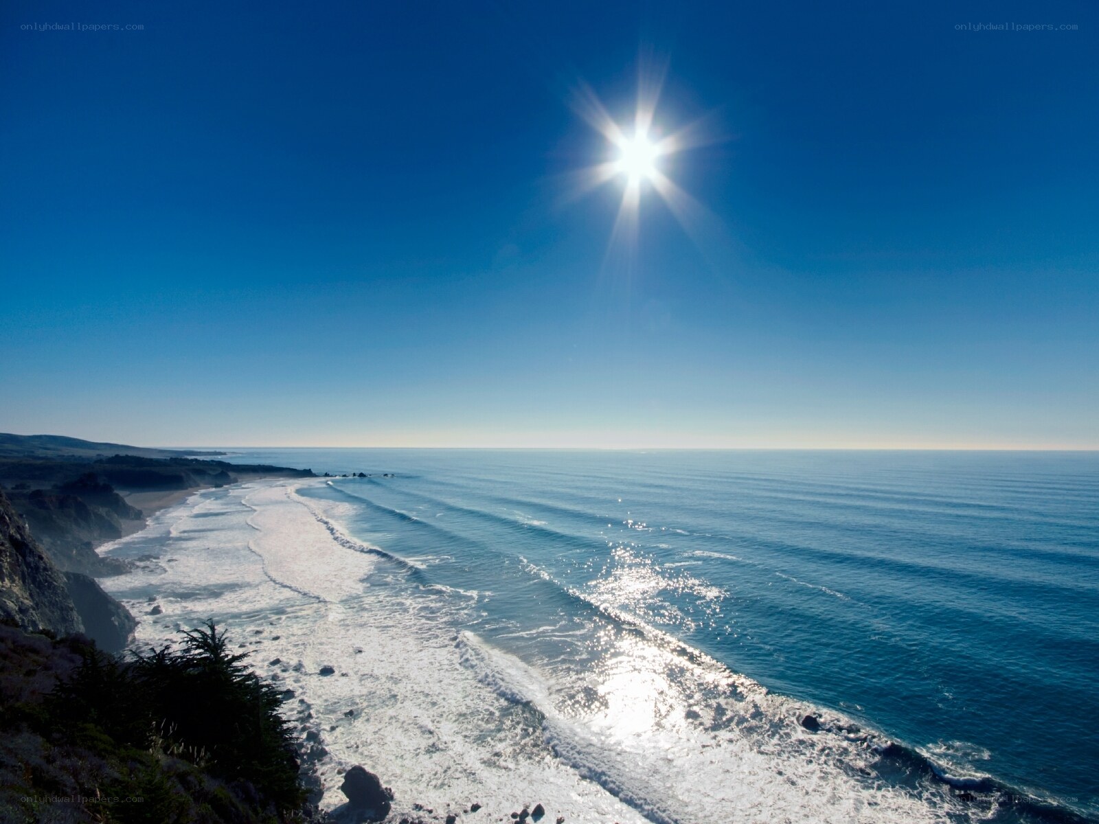Sunlit ocean coastline