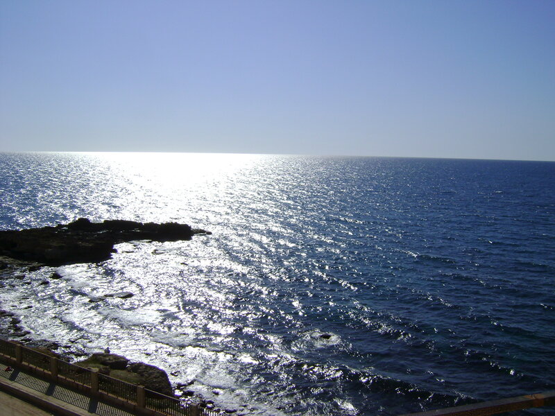 Sunlit ocean view from cliff