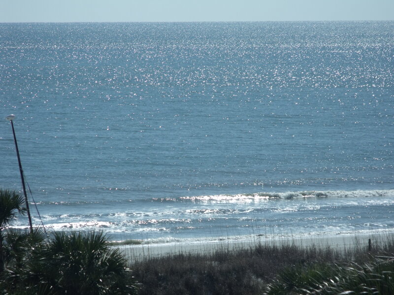 Sunlit ocean waves at beach