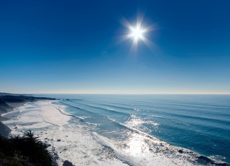 Sunlit ocean waves at coastline