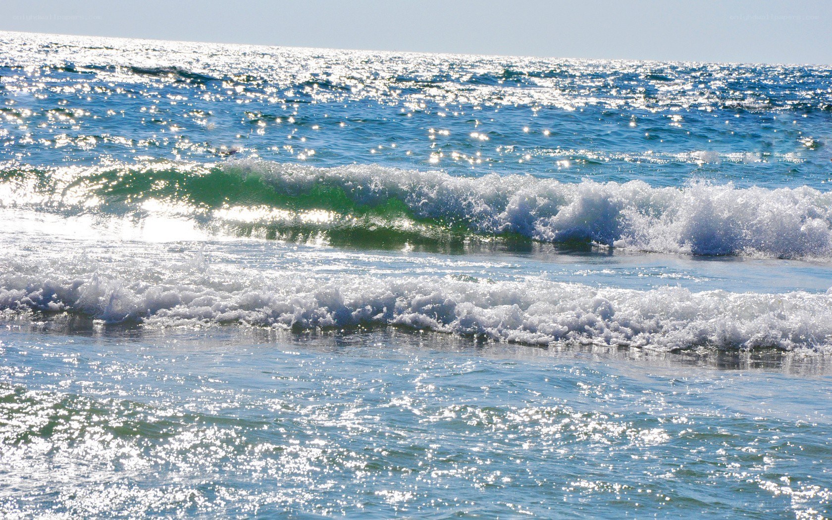 Sunlit ocean waves at the shore
