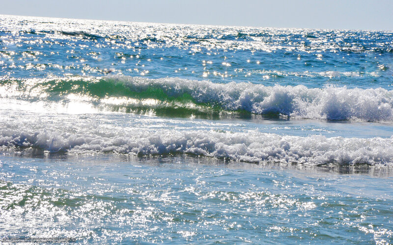 Sunlit ocean waves at the shore