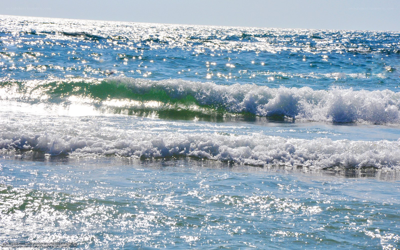 Sunlit ocean waves at the shore