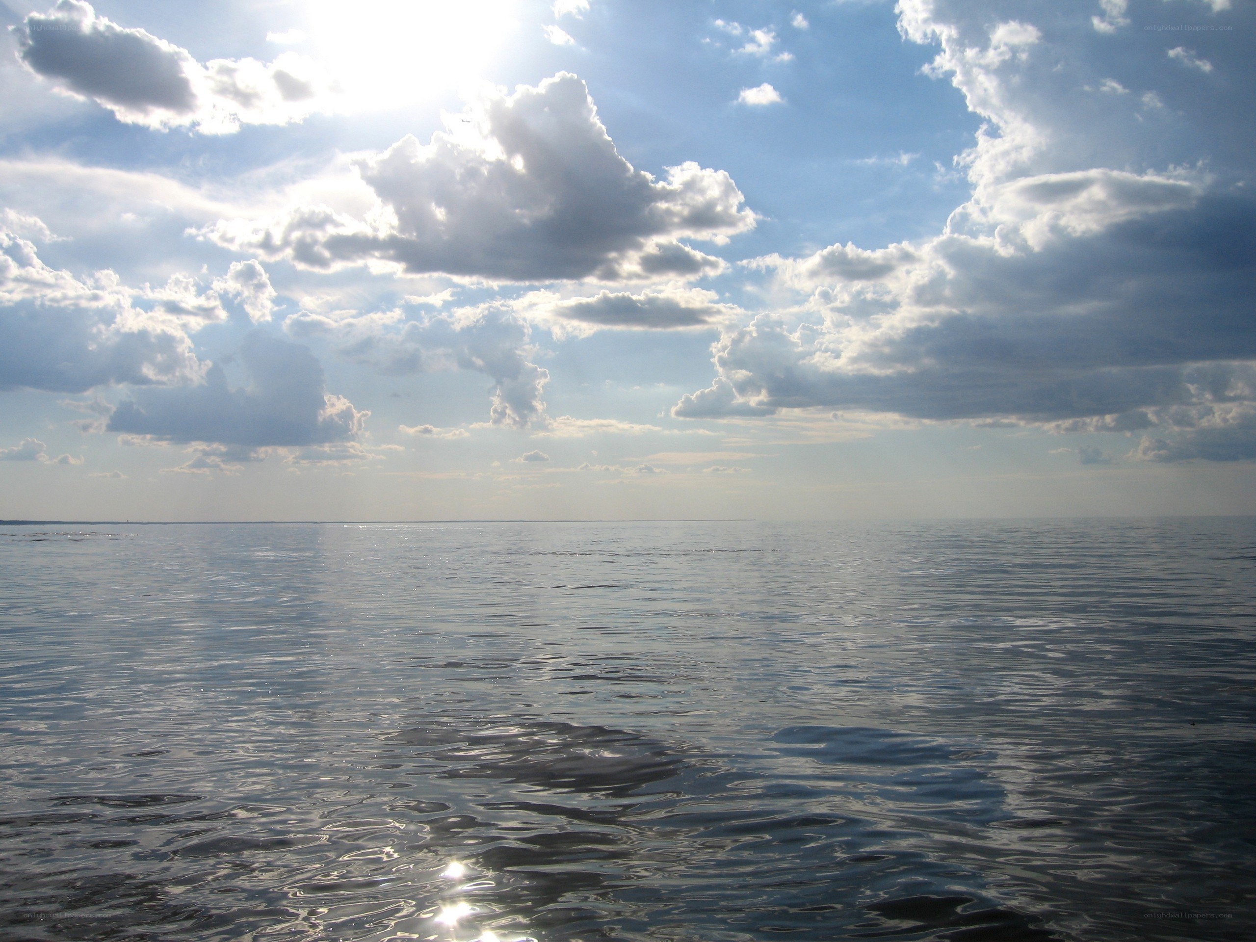 Sunlit ocean with clouds
