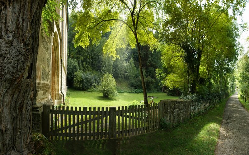 Sunlit path by old church