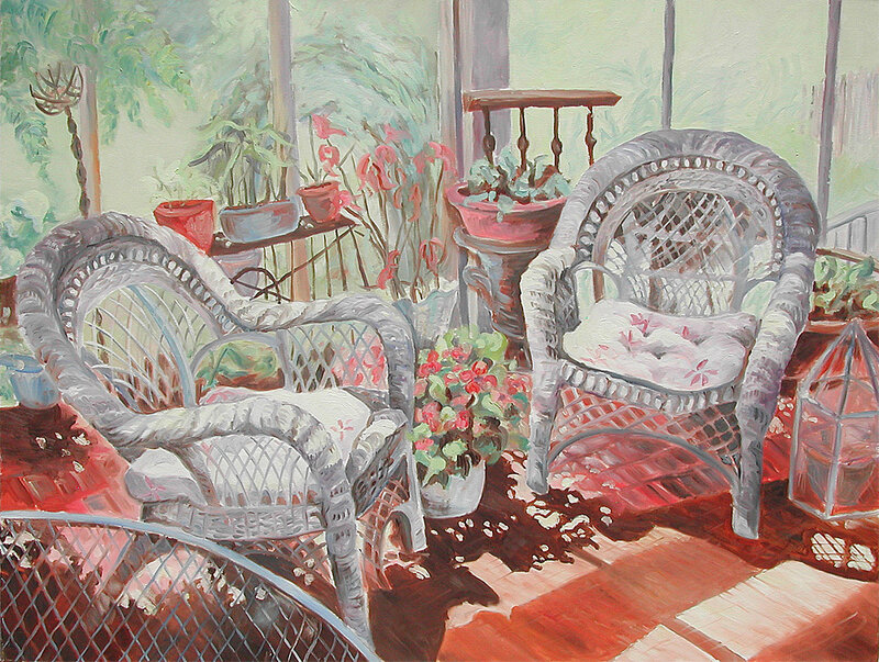 Sunlit porch with wicker chairs