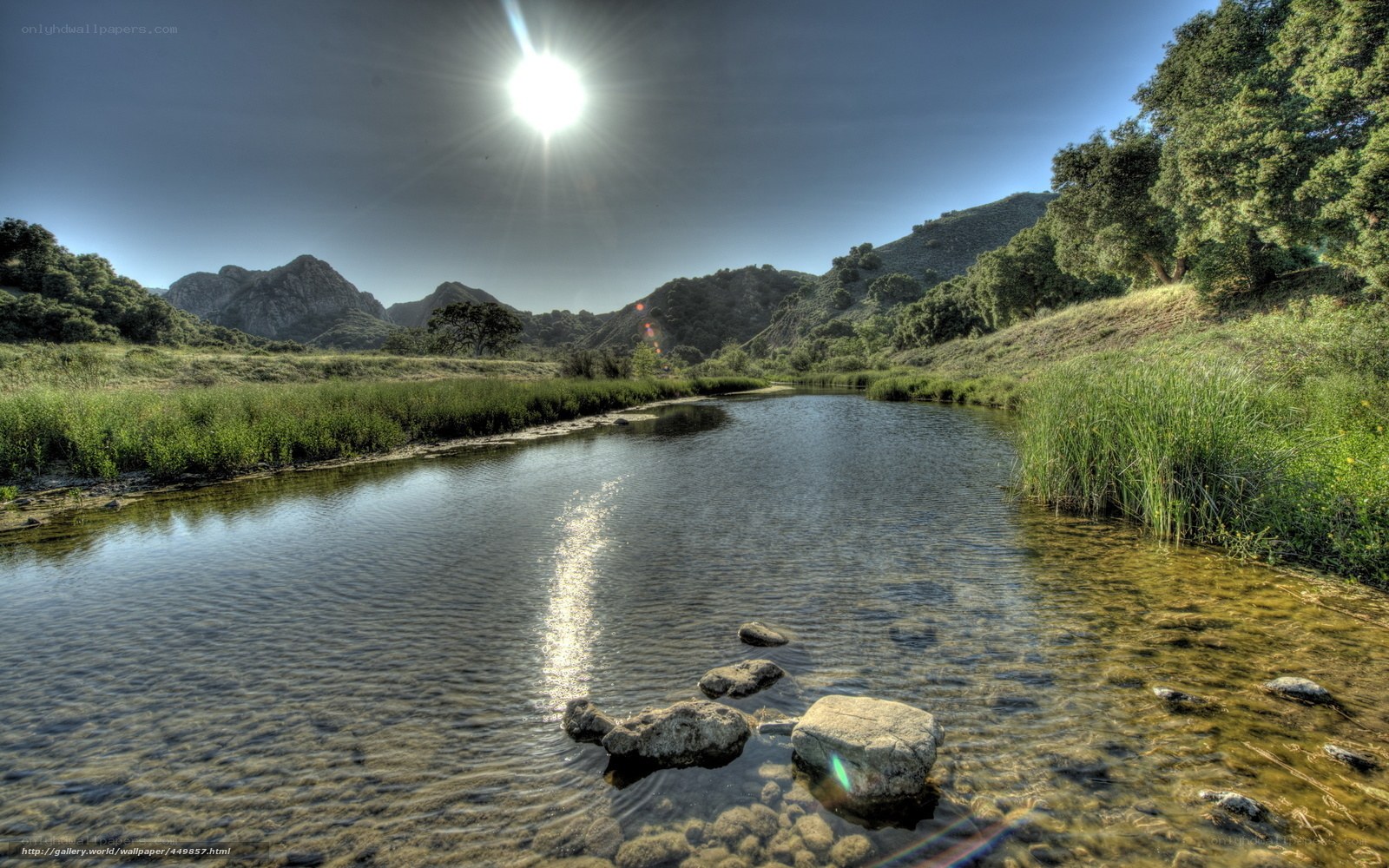 Sunlit river in mountain valley