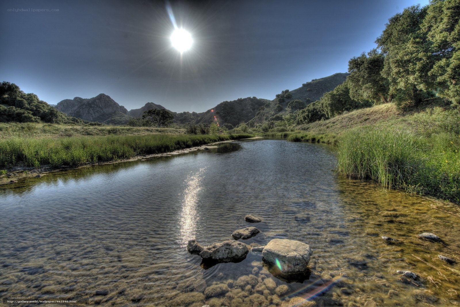 Sunlit river in mountain valley