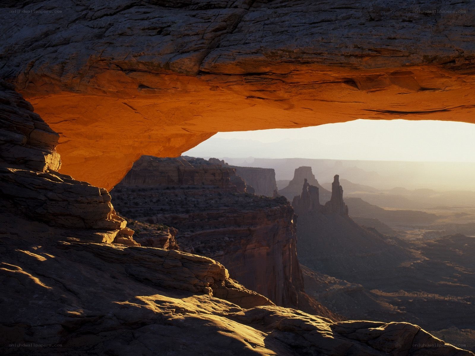 Sunlit rock arch in canyon