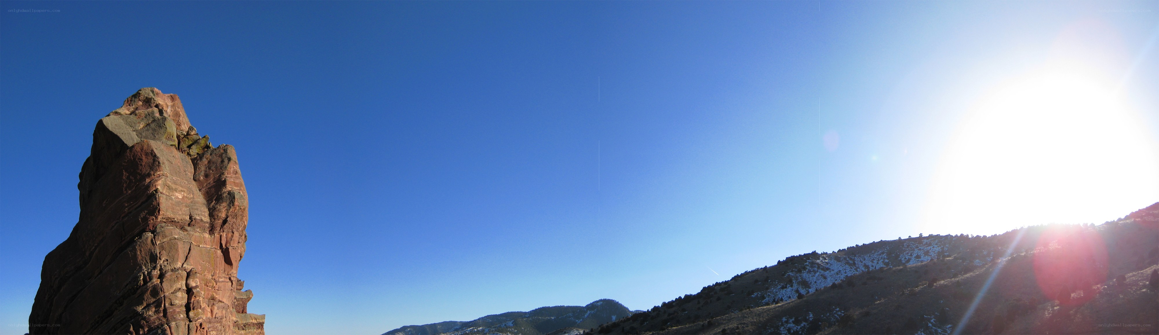 Sunlit rock formation in blue sky