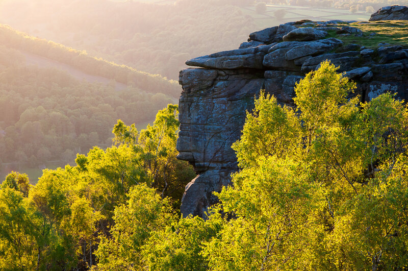 Sunlit rock formation in valley